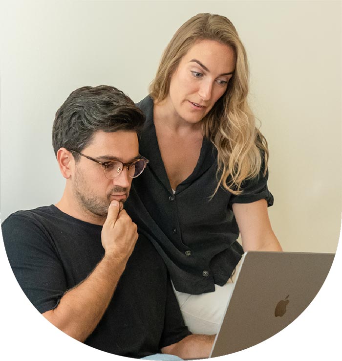 Man and woman look at laptop